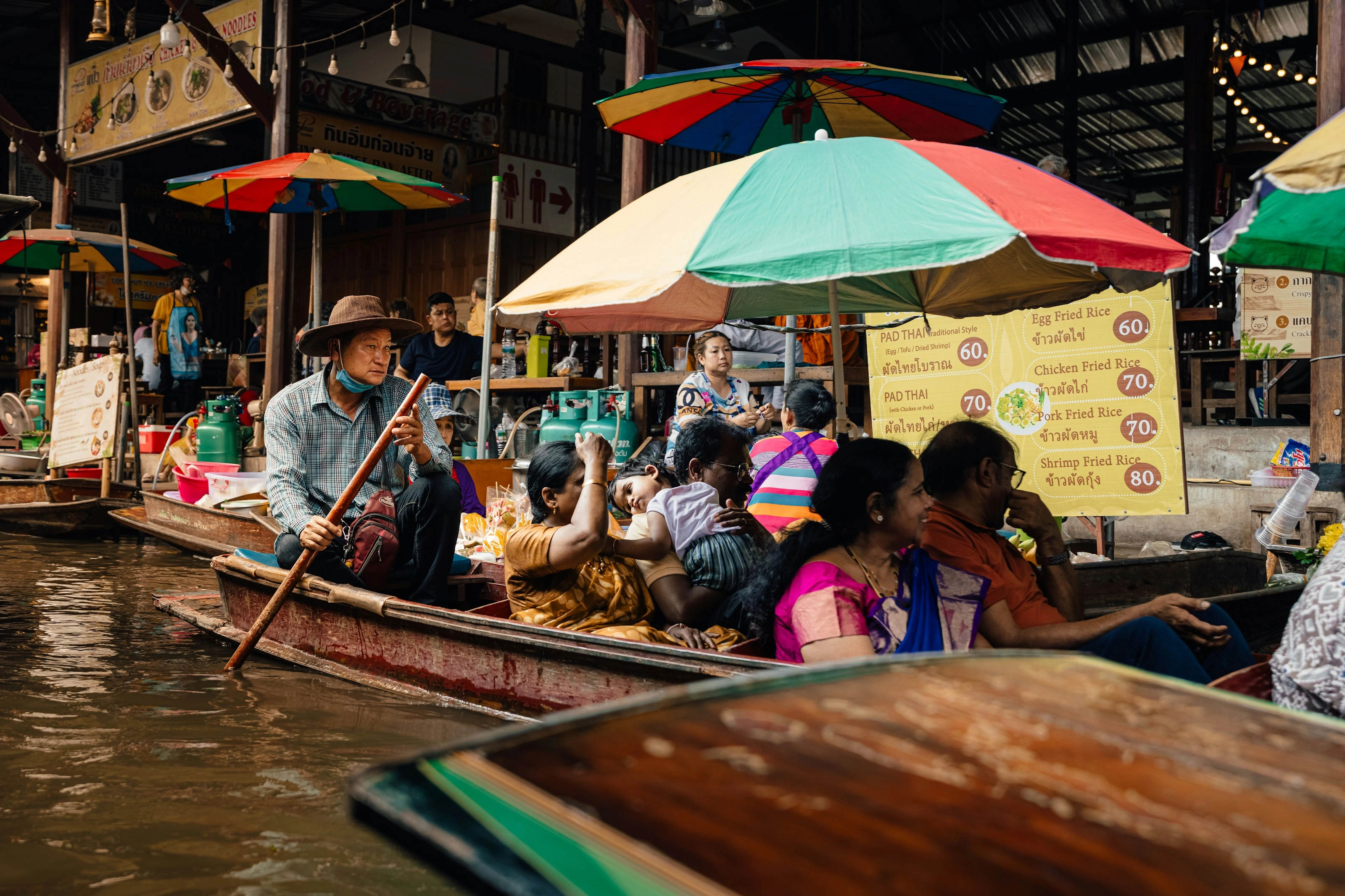 A floating market with vendors selling from boats near Bangkok